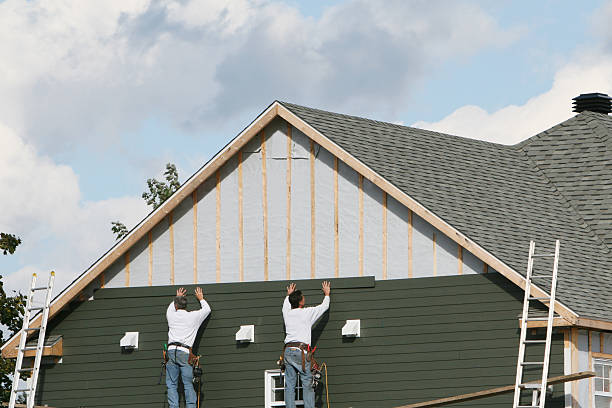 Professional Storm Damage Siding Repair technician working in Moreland, GA